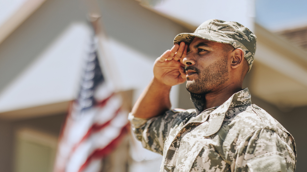 veteran saluting at a flag